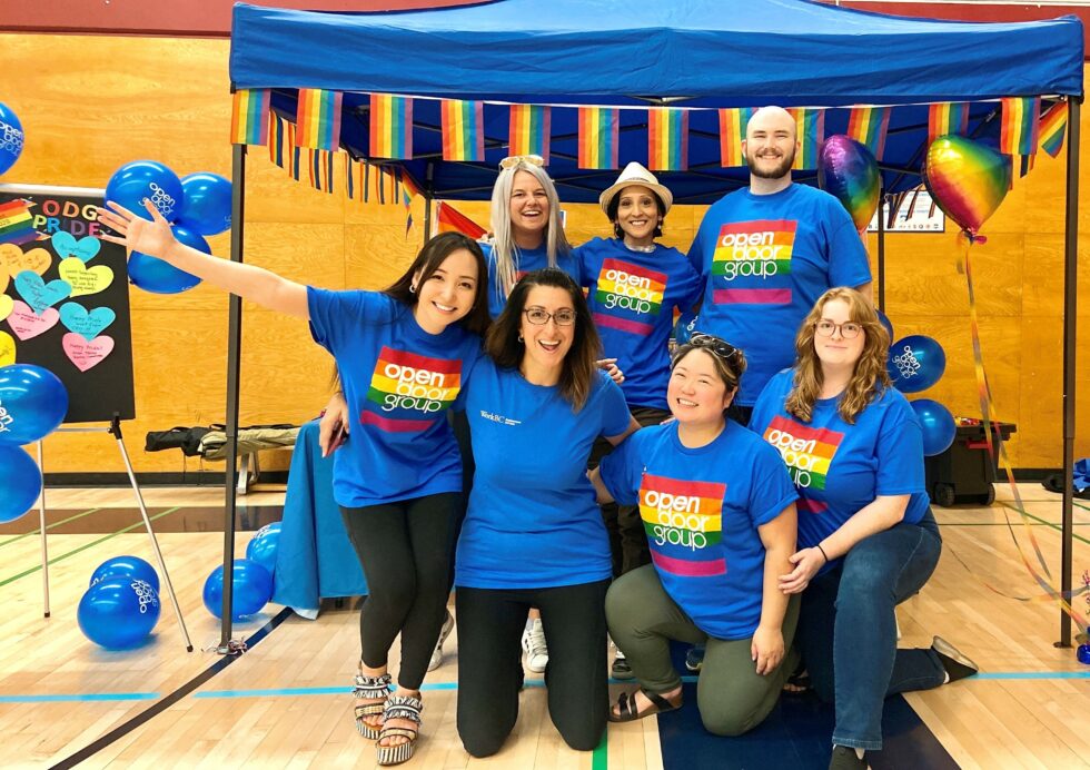 Open Door Group team at the Kamloops Pride Resource Carnival. Our team members from top left to right: Jordyn, Belle, David. From bottom left to right: Jennifer, Anjali, Louise, and Tori.